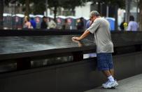 TJ Neary pauses to remember his mother Mauriel Siskocoulos during 9/11 Memorial ceremonies marking the 12th anniversary of the 9/11 attacks on the World Trade Center in New York. September 11, 2013. (REUTERS/Alejandra Villa)