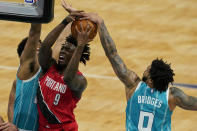 Charlotte Hornets forward Miles Bridges blocks a shot by Portland Trail Blazers forward Nassir Little (9) during the first half in an NBA basketball game on Sunday, April 18, 2021, in Charlotte, N.C. (AP Photo/Chris Carlson)