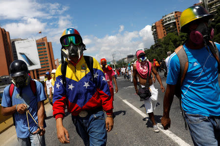 A demonstrator wearing a jacket with the colors of the Venezuelan national flag takes part in a protest against Venezuelan President Nicolas Maduro's government in Caracas, Venezuela May 29, 2017. REUTERS/Carlos Garcia Rawlins