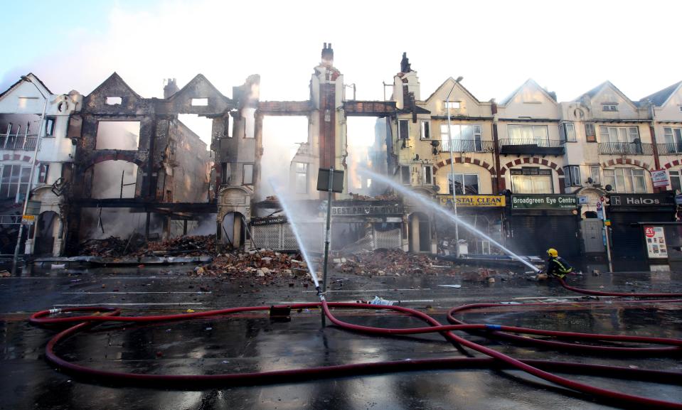 Fire crews douse burnt-out buildings in Croydon during riots in 2011 (Gareth Fuller/PA) (PA Archive)