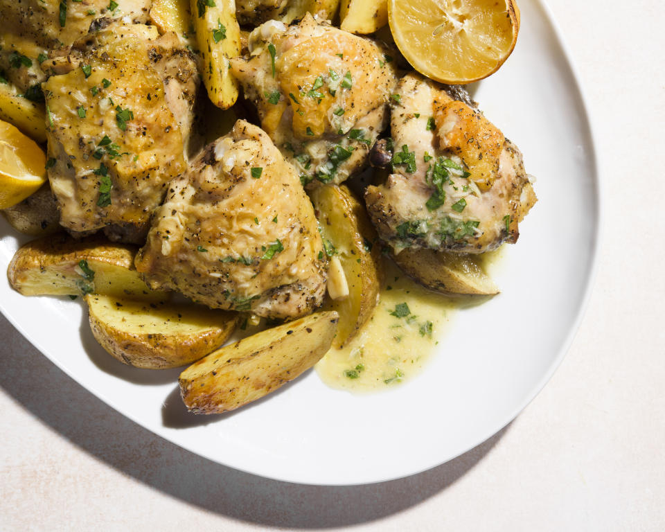 This image released by Milk Street shows a recipe for chicken and potato traybake with garlic, lemon and parsley. (Milk Street via AP)