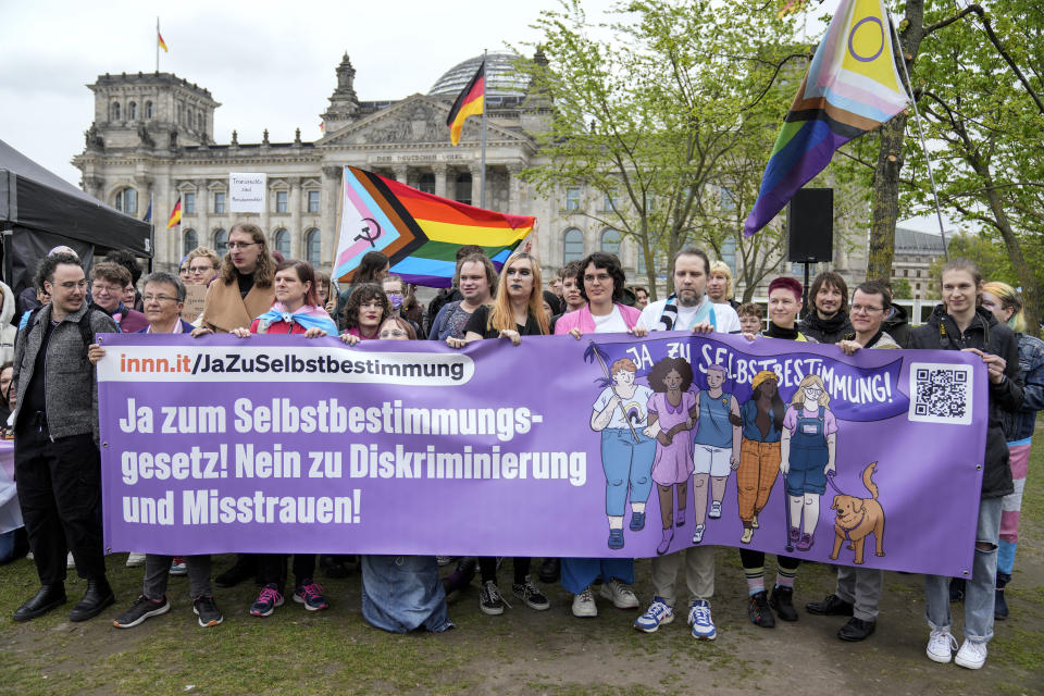 Demonstrators protest demanding a law to protect the rights of the transgender community outside of the parliament Bundestag building in Berlin, Friday, Apri 12, 2024. German lawmakers on Friday approved legislation that will make it easier for transgender, intersex and nonbinary people to change their name and gender in official records. (AP Photo/Ebrahim Noroozi)