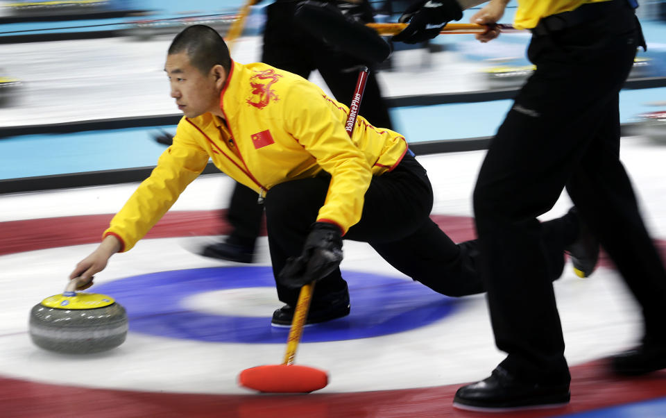 China's skip Liu Rui delivers the rock during the men's curling competition against Germany at the 2014 Winter Olympics, Wednesday, Feb. 12, 2014, in Sochi, Russia. (AP Photo/Wong Maye-E)