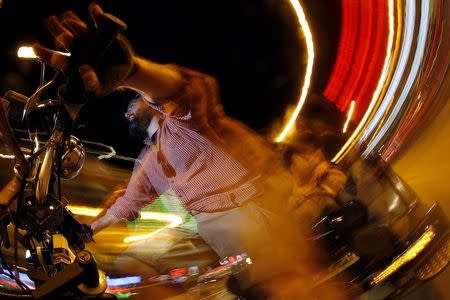 T.C. O'Rourke drives his pedicab in the Wrigleyville neighborhood in Chicago, Illinois, September 19, 2014. REUTERS/Jim Young