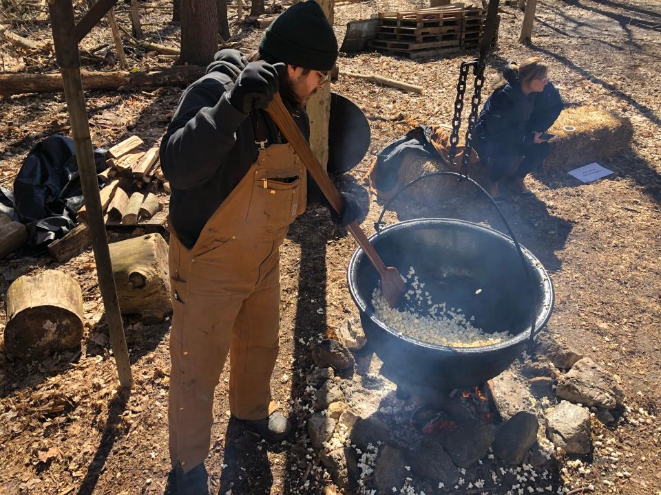A volunteer cooks kettle corn sweetened with maple syrup at Bendix Woods County Park in New Carlisle during Sugar Camp Days in 2023.