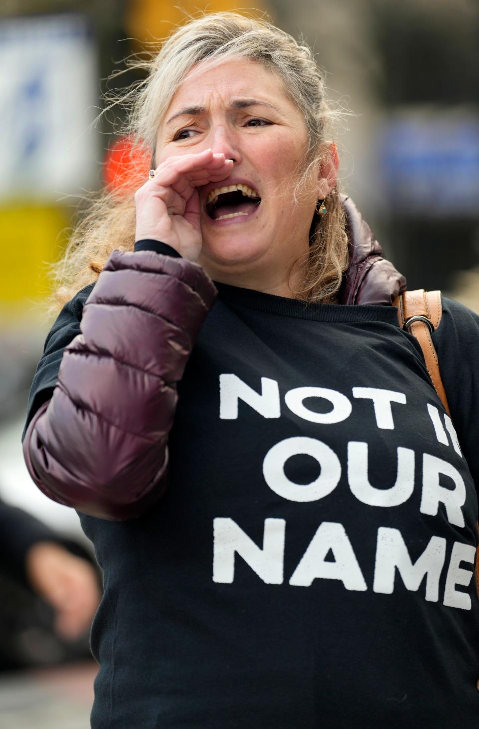 Ariel Gold, of Hawthorne, wears a shirt that says, "NOT IN OUR NAME'. Gold, of Jewish Voice for Peace, Northern New Jersey and Fellowship of Reconciliation, was among the organizers of a cease fire rally in Newark, Monday, November 13, 2023.
