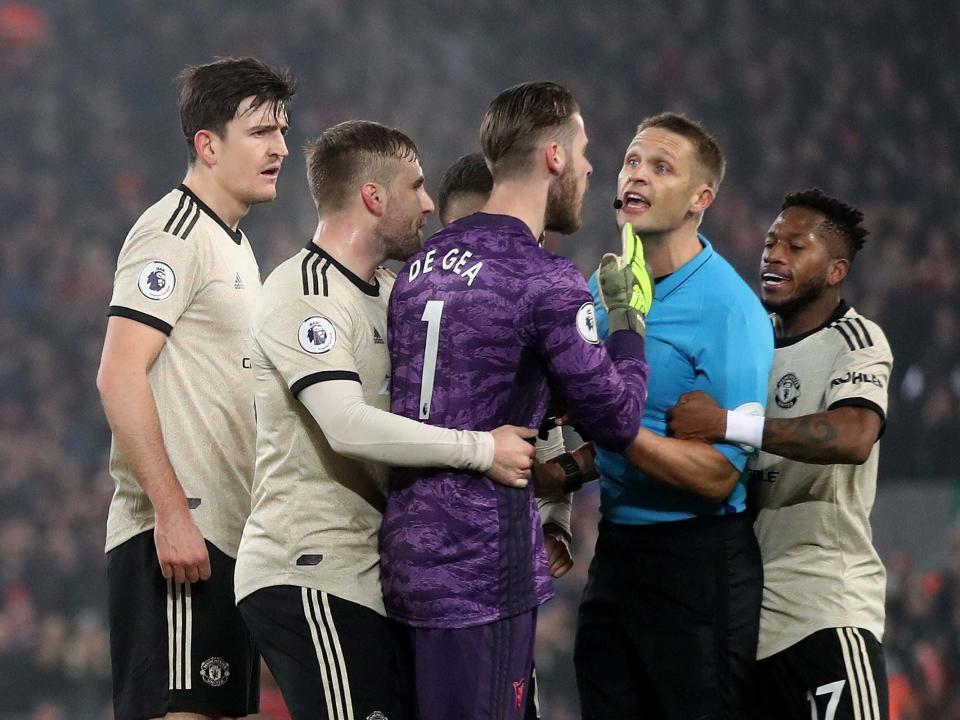 Manchester United confront the referee Craig Pawson: Reuters