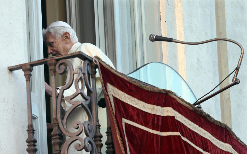 FILE - Pope Benedict XVI leaves after greeting the faithful from the balcony window of the papal summer residence of Castel Gandolfo, the scenic town where he spent his first post-Vatican days and made his last public blessing as pope, Feb. 28, 2013. Pope Emeritus Benedict XVI's death has hit Castel Gandolfo's "castellani" particularly hard, since many knew him personally, and in some ways had already bid him an emotional farewell when he uttered his final words as pope from the palace balcony overlooking the town square. (AP Photo/Alessandra Tarantino, File)