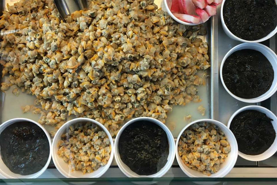 Laverbread and cockles at a market in Swansea, Wales