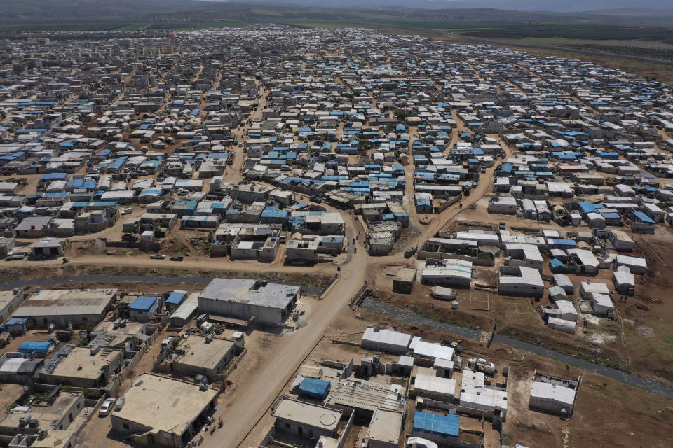 FILE - This April 19, 2020 file photo shows a large refugee camp on the Syrian side of the border with Turkey, near the town of Atma, in Idlib province, Syria. The head of the U.N. food agency warned of starvation and another wave of mass migration from Syria to Europe unless donors countries step up financial assistance to the war-ravaged country. (AP Photo/Ghaith Alsayed, File)