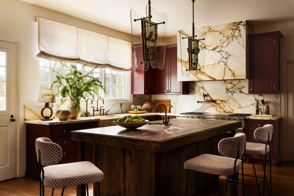 a kitchen with a marble island