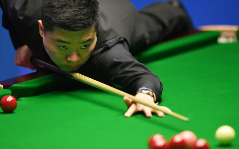 China's Ding Junhui plays a shot against China's Zhou Yuelong during their first round game of the World Snooker Championships in Sheffield, northern England, on April 18, 2017