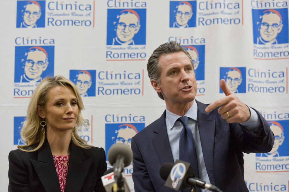 California Gov. Gavin Newsom with his wife, Jennifer Siebel Newsom attend a roundtable discussion with Central American community leaders at the Clinica Monsenor Oscar Romero in Los Angeles Thursday, March 28, 2019. Newsom said Thursday he will travel to El Salvador in April to discuss the poverty and violence that's causing waves of migrants to seek asylum in the United States. (AP Photo/Damian Dovarganes)