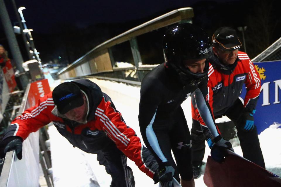 WINTERBERG, GERMANY - DECEMBER 08: Olympic champion Lolo Jones of United States pushes the bob during the team competition of the FIBT Bob & Skeleton World Cup at Bobbahn Winterberg on December 8, 2012 in Winterberg, Germany. (Photo by Christof Koepsel/Bongarts/Getty Images)