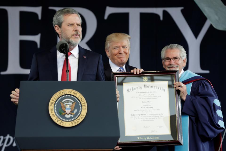 <p>U.S. President Donald Trump (C) is awarded a doctorate degree before delivering keynote address at Liberty University’s commencement in Lynchburg, Virginia, May 13, 2017. (Photo: Yuri Gripas/Reuters) </p>