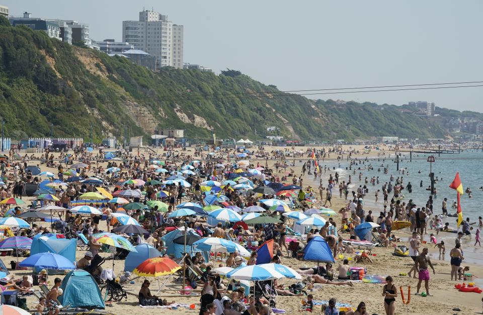 People enjoy the warm weather on Bournemouth beach in Dorset. (PA)