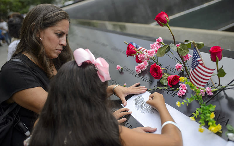 Family of a Sept. 11 victim etch her name onto paper