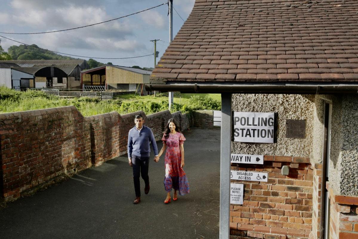 Rishi Sunak and wife Akshata Murty arrive at Kirby Sigston Village Hall to vote. <i>(Image: SARAH CALDECOTT)</i>