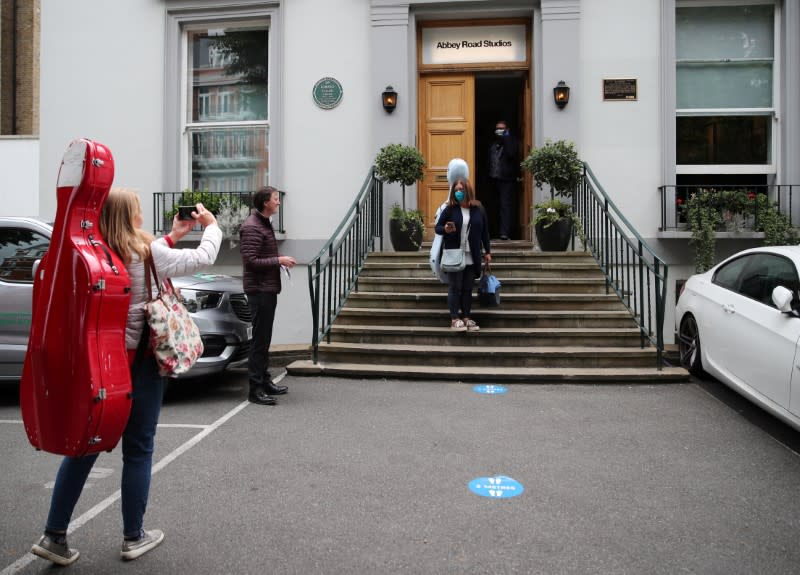 Members of the Royal Philharmonic Orchestra wait to enter the world famous Abbey Road Studios as they reopen after an extended lockdown, due to the spread of the coronavirus disease (COVID-19) in London