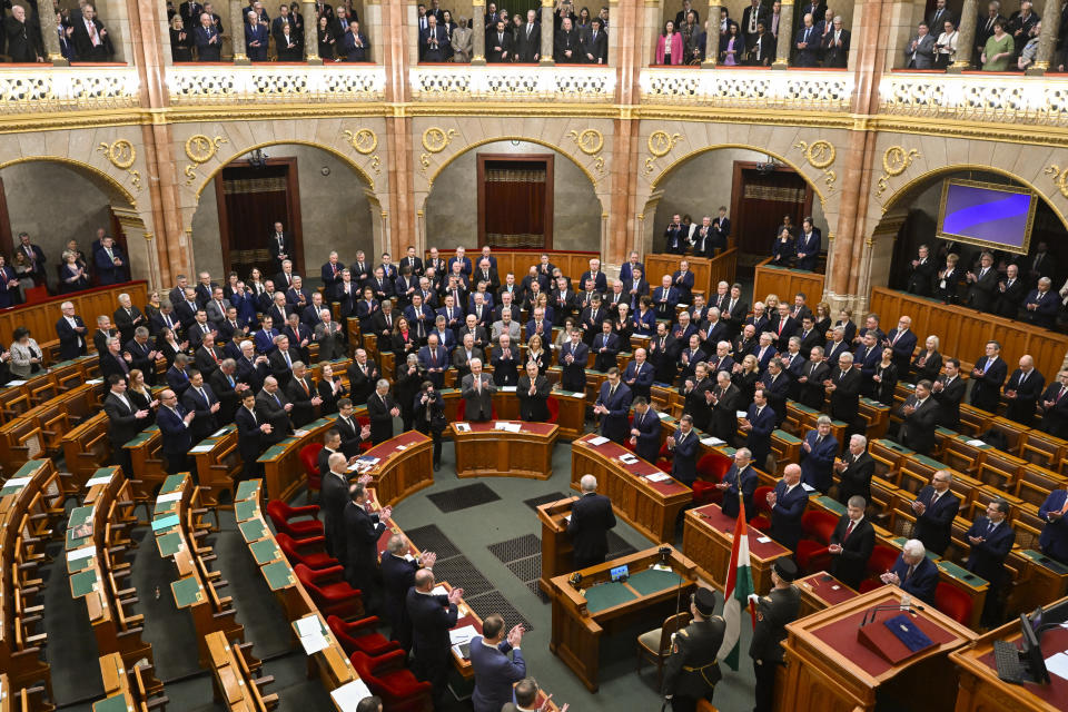 Tamas Sulyok, center, the former head of Hungary's Constitutional Court, takes the oath as the country's President after being voted in by lawmakers in a parliament session, in Budapest, Hungary, Monday, Feb 26, 2024. Hungary's former president, Katalin Novak, stepped down in February, over a pardon she issued to an accomplice in a child sexual abuse case.(AP Photo/Denes Erdos)