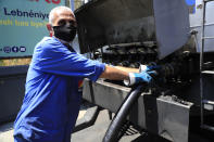 A worker pumps gasoline from a fuel truck to supply a gas station in Beirut, Lebanon, Friday, June 25, 2021. Lebanon's caretaker prime minister on Friday granted his approval to allow the financing of fuel imports at a rate higher than the official exchange rate, effectively reducing critical fuel subsidies that have been in place for decades, amid worsening gasoline shortages. (AP Photo/Hussein Malla)