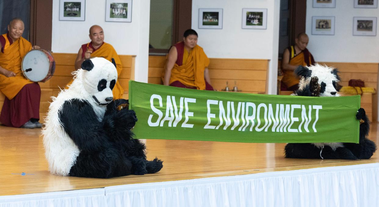 Tibetan monks share a message with students during the Dance of the Giant Panda while visiting Canton Country Day School. The visit was part of five-day tour in Canton sponsored by Yoga Central.