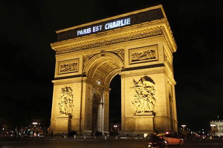 The message "Paris is Charlie" is projected on the Arc de Triomphe in Paris January 9, 2015, in tribute to the victims following Wednesday's deadly attack at the Paris offices of weekly satirical newspaper Charlie Hebdo by two masked gunmen who shouted Islamist slogans. REUTERS/Youssef Boudlal