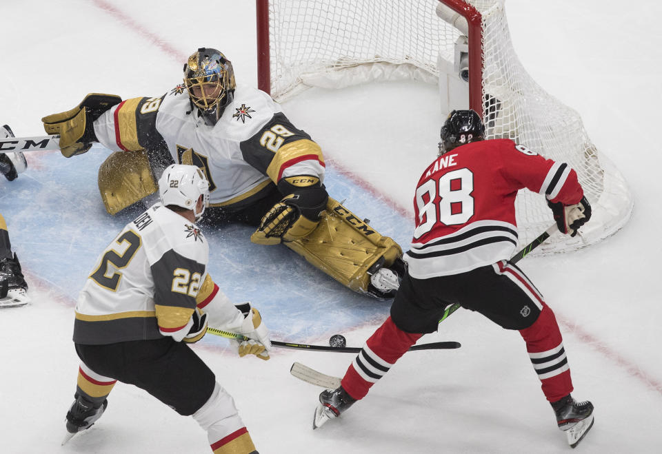 Vegas Golden Knights goalie Marc-Andre Fleury (29) makes a save on Chicago Blackhawks' Patrick Kane (88) as Nick Holden (22) defends during the third period of Game 3 of an NHL hockey first-round playoff series, Saturday, Aug. 15, 2020, in Edmonton, Alberta. (Jason Franson/The Canadian Press via AP)