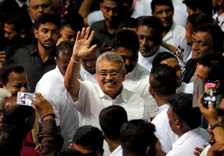 FILE PHOTO: Sri Lanka's former defense secretary Gotabaya Rajapaksa waves after he was nominated as a candidate for the presidential election during the Sri Lanka People's Front party convention in Colombo