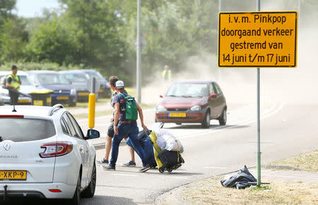 Visitors leave the festival grounds near a scene where a van struck into people after a concert at the Pinkpop festival in Landgraaf, the Netherlands June 18, 2018. REUTERS/Thilo Schmuelgen