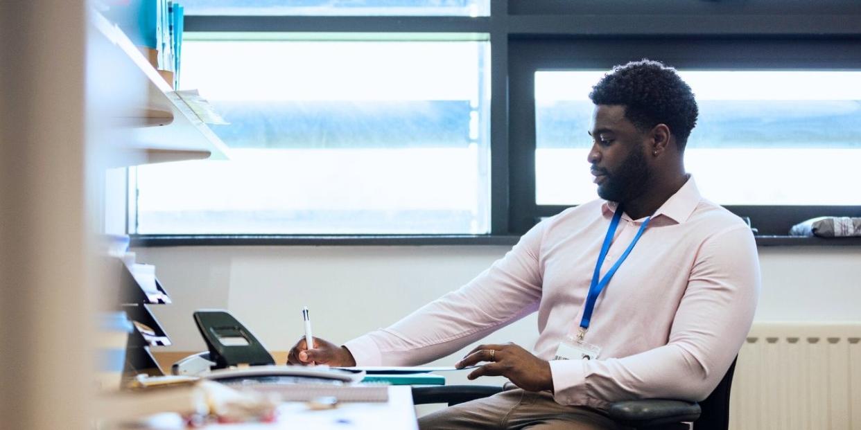 Teacher grading papers in the classroom