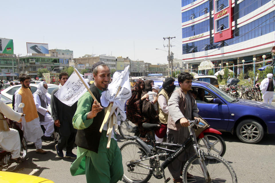 A man sells Taliban flags in Herat province, west of Kabul, Afghanistan, on Saturday, Aug. 14, 2021. (AP Photo/Hamed Sarfarazi)