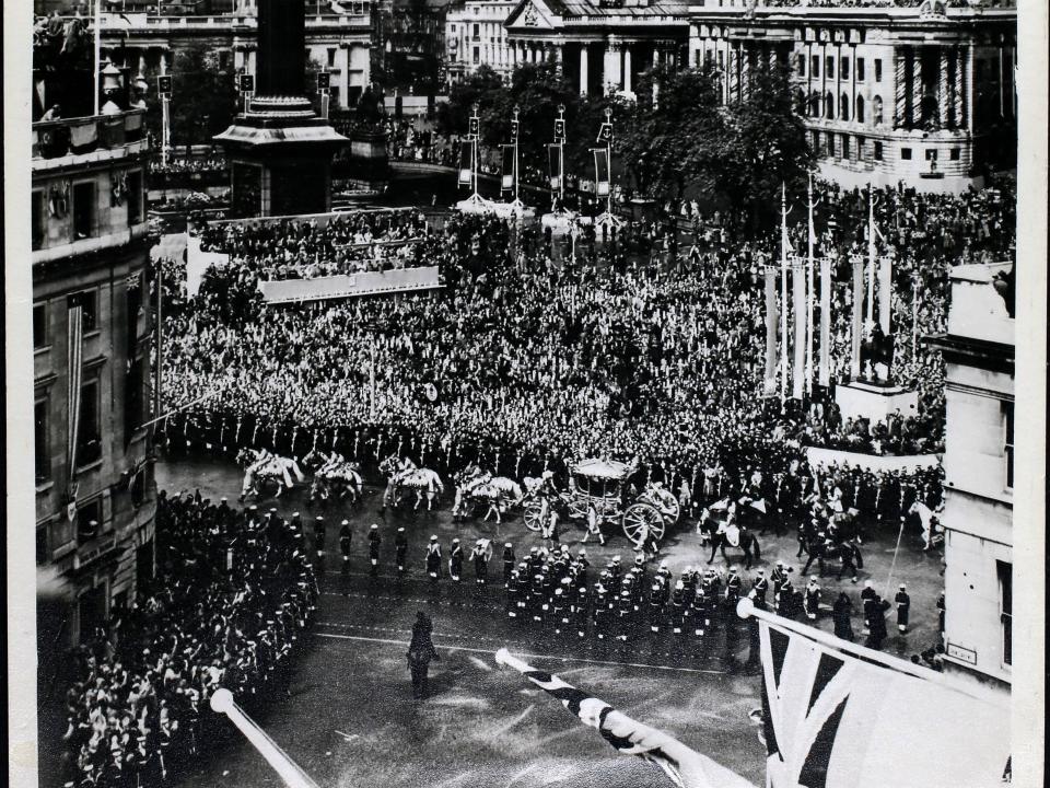 Crowds of people line the streets of London in 1953.