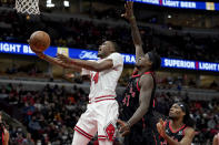 Chicago Bulls' Javonte Green (24) scores past Toronto Raptors' Pascal Siakam during the second half of an NBA basketball game Wednesday, Jan. 26, 2022, in Chicago. The Bulls won 111-105. (AP Photo/Charles Rex Arbogast)