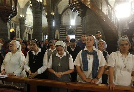 Nuns pray during mass in the Catholic Patriarchate in Damascus, September 7, 2013. REUTERS/Khaled al Hariri