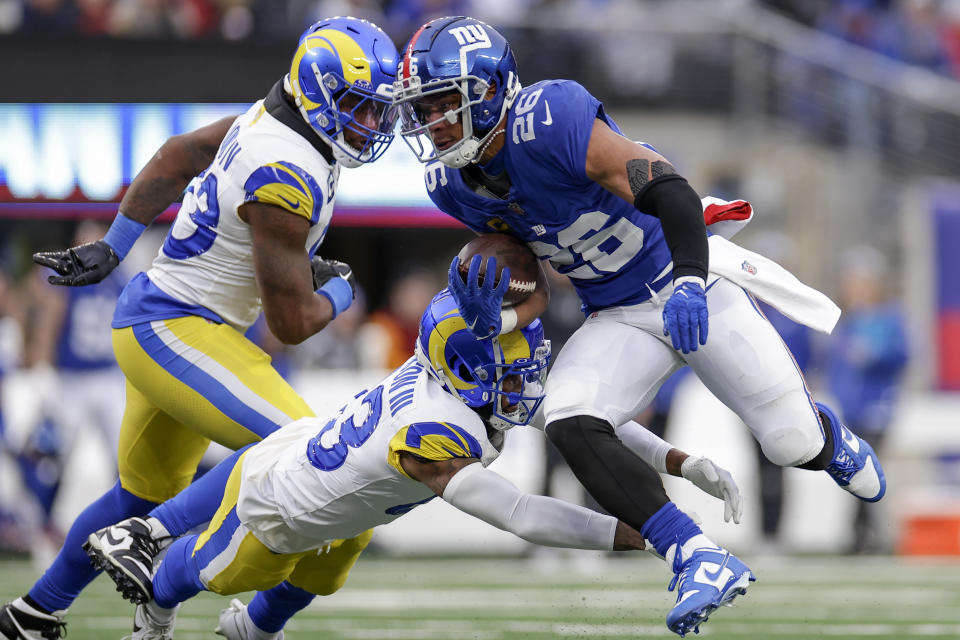 New York Giants running back Saquon Barkley (26) runs the ball against Los Angeles Rams safety John Johnson III (43) during the second half an NFL football game, Sunday, Dec. 31, 2023, in East Rutherford, N.J. (AP Photo/Adam Hunger)