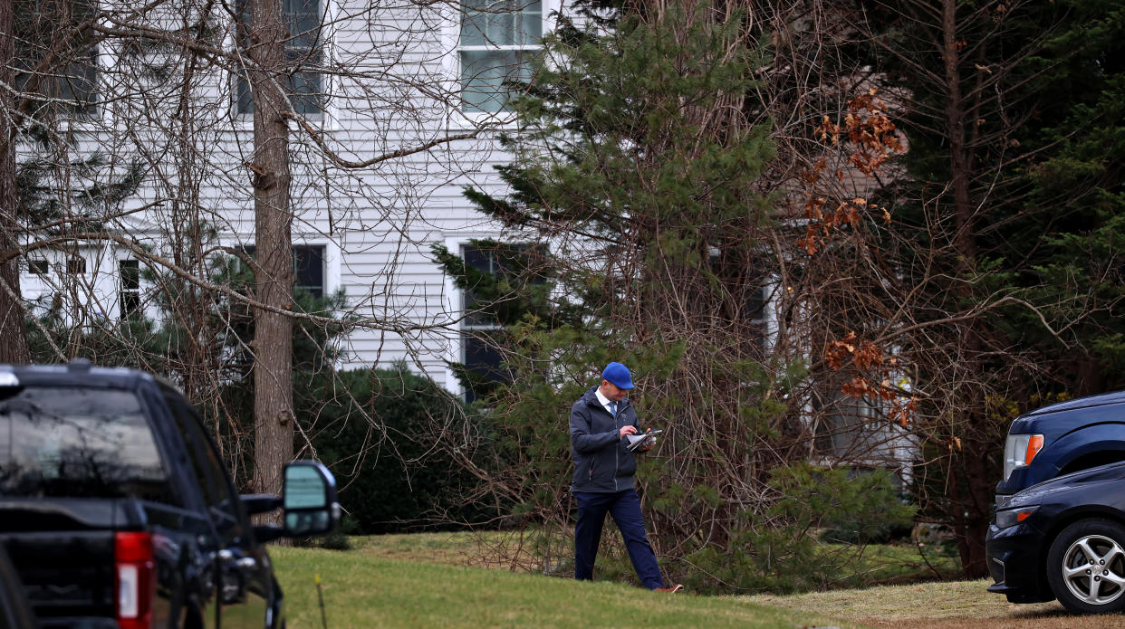 An investigator walks outside the home of Brian and Ana Walshe.