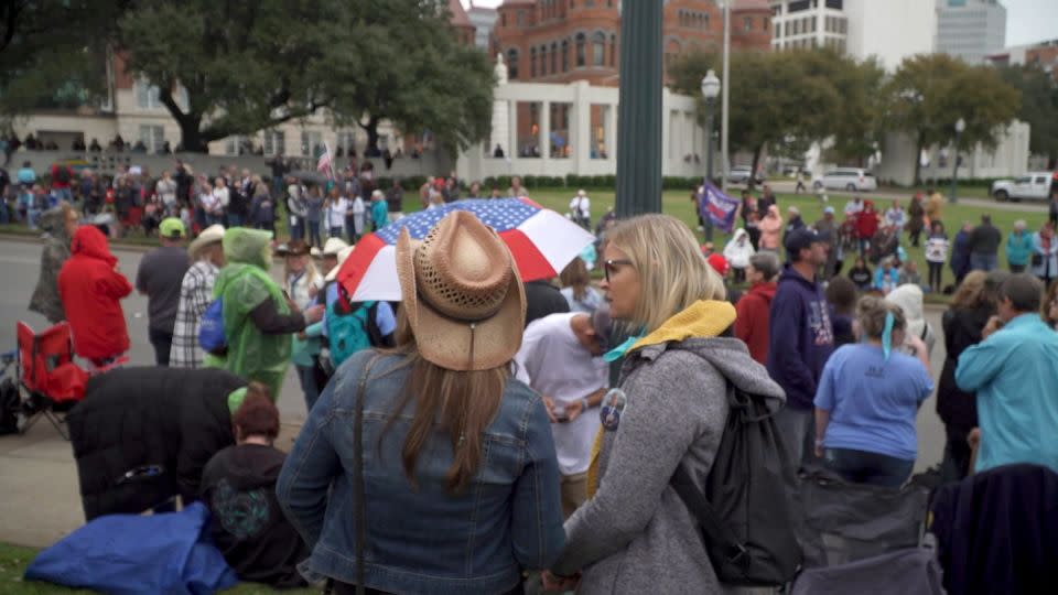 A crowd gather on the grassy knoll in Dallas in November 2021  - WFAA