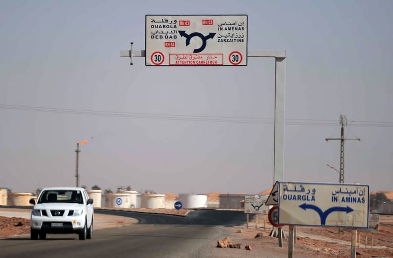 A car drives past an Algerian oil installation on the outskirts of In Amenas, deep in the Sahara near the Libyan border, on January 18, 2013. Islamist gunmen were holed up with an unknown number of foreign hostages on Saturday at a gas plant in the Algerian desert, amid uncertainty over what the army was doing to free their captives