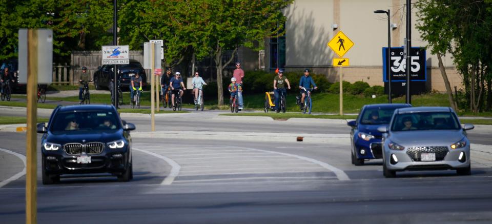 Bikers navigate the bike path along Indiana Avenue, Friday, May 26, 2023, in Sheboygan, Wis.