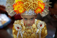 August, 8, is dressed up for an annual Poy Sang Long procession, part of the traditional rite of passage for boys to be initiated as Buddhist novices, in Mae Hong Son, Thailand, April 3, 2018. REUTERS/Jorge Silva