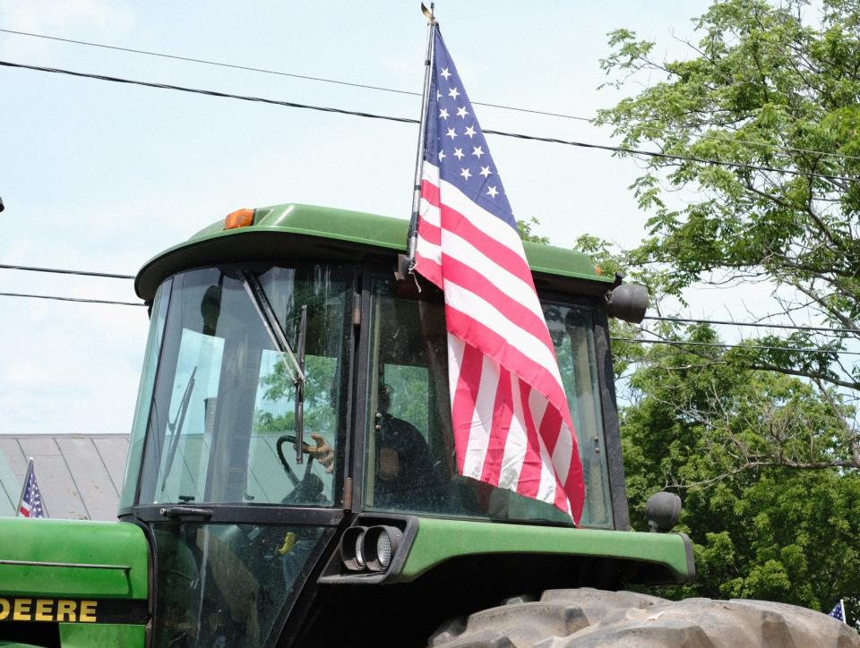 The annual Independence Day tractor parade makes its way up Church Street in Peacham, Vt., on Thursday, July 4, 2019.