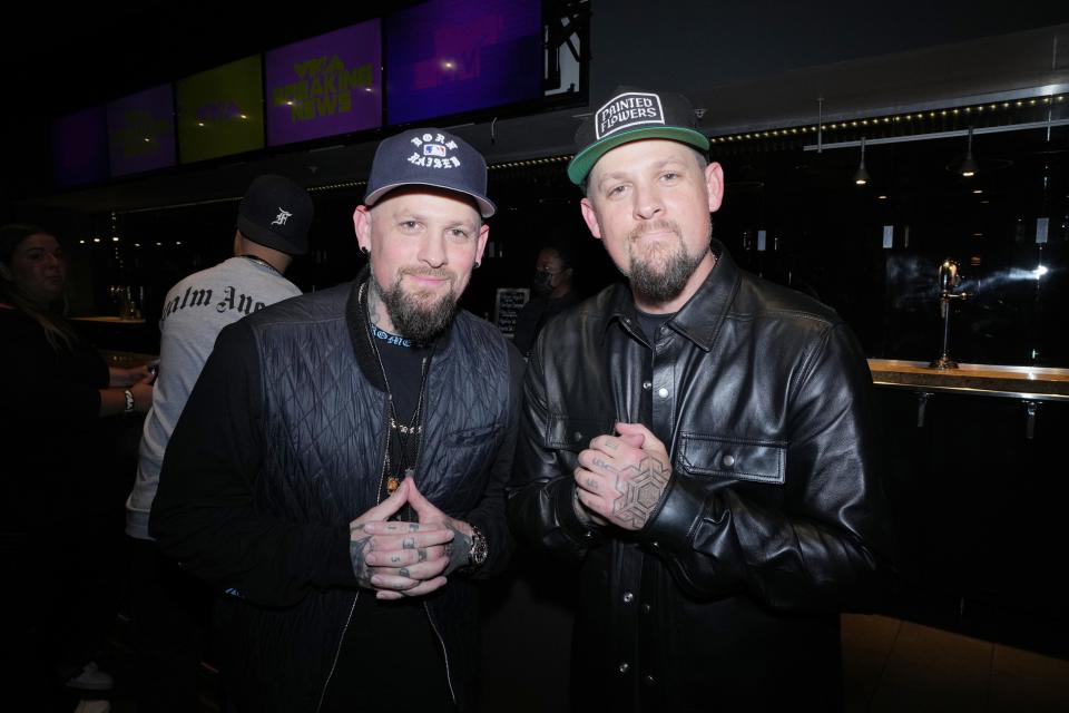 Joel and Benji Madden stand side by side at an event.