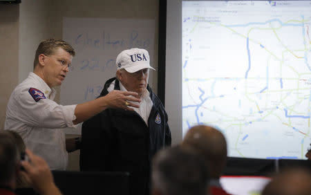 U.S. President Donald Trump (C) llistens during a briefing on Tropical Storm Harvey relief efforts at the Texas Department of Public Safety Emergency Operations Center in Austin, Texas, U.S., August 29, 2017. REUTERS/Carlos Barria