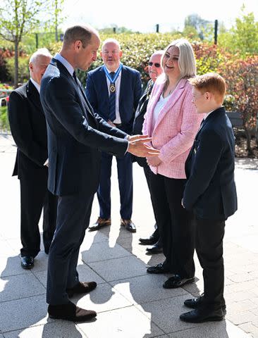 <p>Oli Scarff - WPA Pool/Getty Images</p> Prince William (left) meets Freddie Hadley at St. Michael's Church of England High School on April 25, 2024