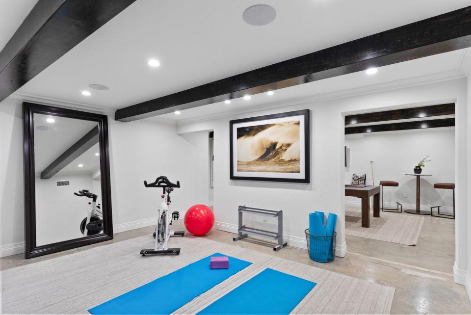 <p>Take advantage of the cooler temps in the basement and install a home gym, yoga room, or whatever type of fitness center floats your boat. Use a mirror, like the one seen here in the basement of art director <a href="http://www.nourmand.com/real-estate/2501-n-vermont-ave-los-angeles-ca-90027/20-594522/95932126" rel="nofollow noopener" target="_blank" data-ylk="slk:L. Milton Wolf's L.A. home;elm:context_link;itc:0;sec:content-canvas" class="link ">L. Milton Wolf's L.A. home</a>, to make a space feel larger and to help you make sure your alignment is correct as you work out. </p>