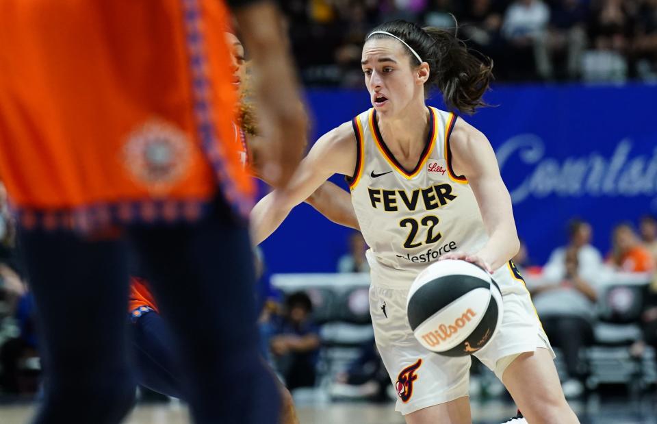 Indiana Fever guard Caitlin Clark (22) drives the ball against the Connecticut Sun in the second half at Mohegan Sun Arena.