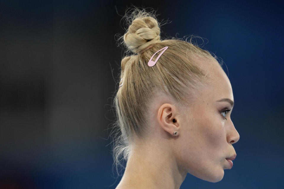 Angelina Melnikova, of the Russian Olympic Committee, stands to perform on the vault during the women's artistic gymnastic qualifications at the 2020 Summer Olympics, Sunday, July 25, 2021, in Tokyo. (AP Photo/Natacha Pisarenko)