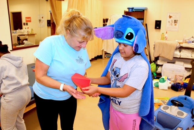 URI nursing professor Christine McGrane coordinates a respite care program each Saturday afternoon, helping provide some temporary relief for parents of children with special needs.