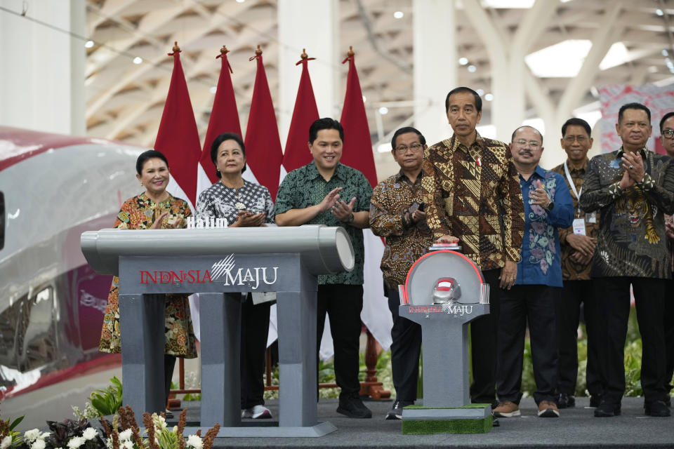 Indonesian President Joko Widodo press a bell during the opening ceremony for launching Southeast Asia's first high-speed railway at Halim station in Jakarta, Indonesia, Monday, Oct. 2, 2023. Indonesian President Joko Widodo launched Southeast Asia's first high-speed railway that will start its commercial operations on Monday, a key project under China's Belt and Road infrastructure initiative that will cut travel time between two cities from the current three hours to about 40 minutes. (AP Photo/Achmad Ibrahim)